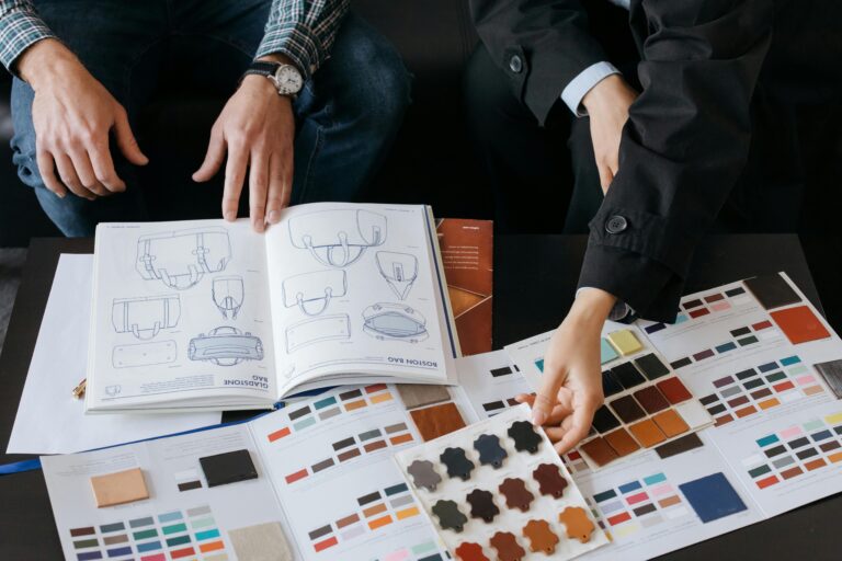 Two professionals choosing color swatches and bag designs for a fashion project. with best quality T-shirts for printing